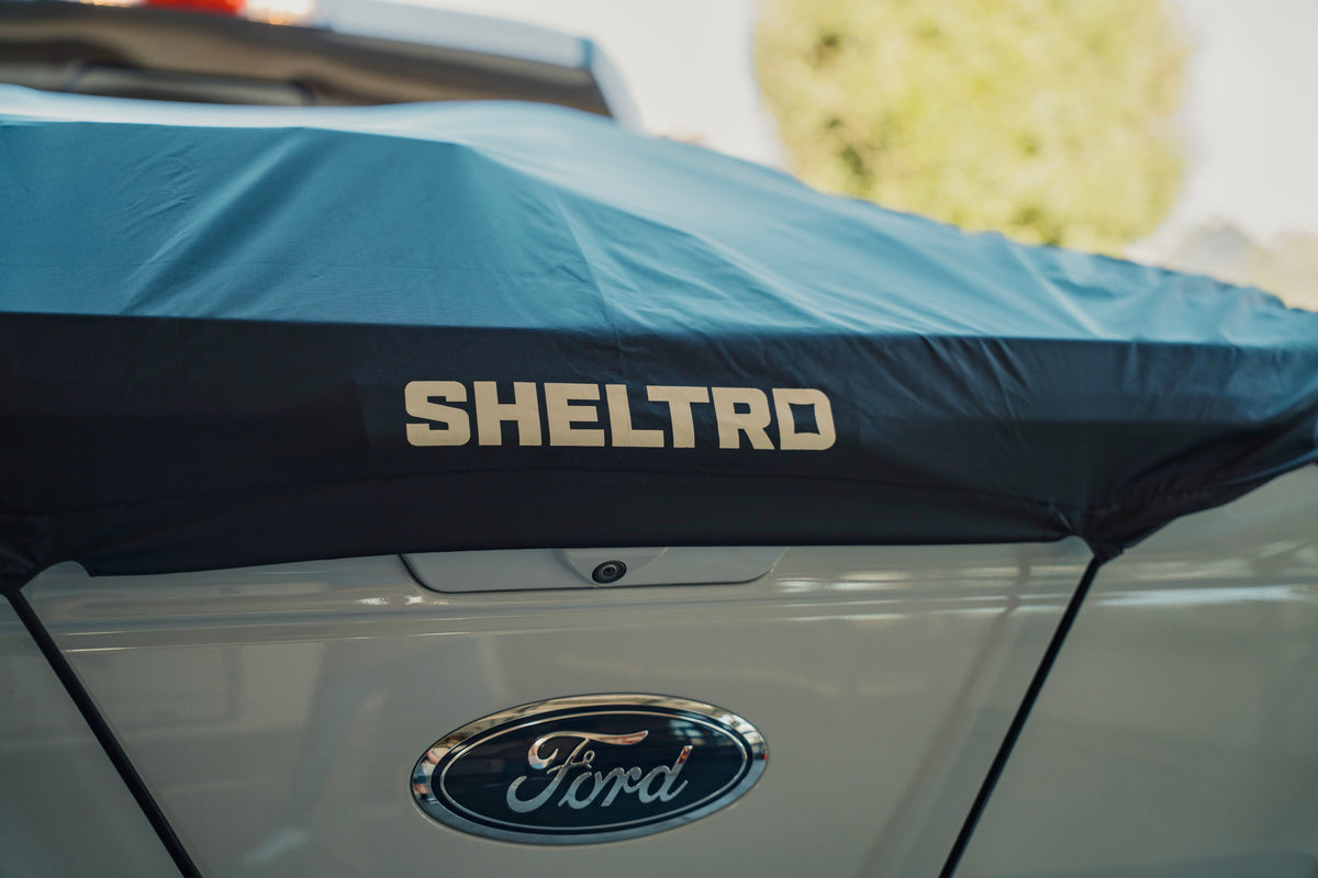 Sheltrd flexible truck bed cover across the tailgate of a Ford F-150